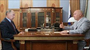 Russian Prime Minister Vladimir Putin (left) listens to Moscow Mayor Yury Luzhkov, 10 August