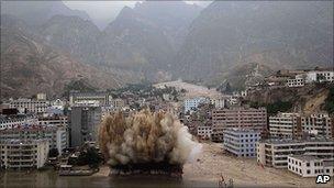 Explosives are set off to clear debris in Zhouqu, 10 August 2010