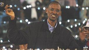 Rwandan President Paul Kagame waves to surpporters during an celebration rally at the Amahoro stadium on Monday 10 August