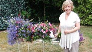Linda Martin with some of her hanging baskets