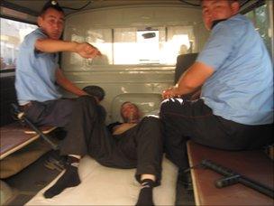 Kazakh police van with injured prisoner - one of 38 inmates who mutilated themselves in July (Image: Vadim Kuramshin)