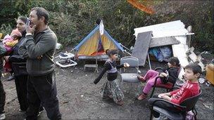 A Roma family stand in their illegal camp in Lesquin, near Lille