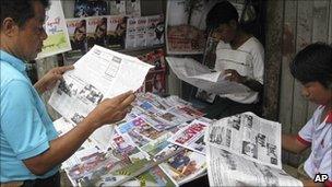 Burmese read news of the election in Rangoon, 12 August