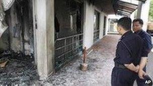 Kuala Lumpur police officers inspect the damage to the Metro Tabernacle Church