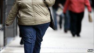 Obese woman walking down the street