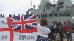 Child welcomes home HMS Ark Royal with banner