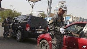 Police officers at a Baghdad checkpoint, file image