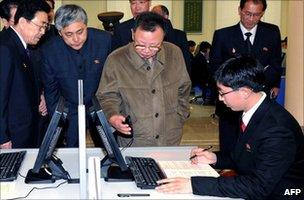 North Korean leader Kim Jong-il holding a computer's mouse