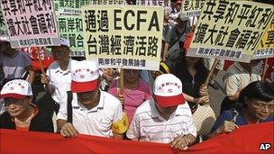 Supporters of the ECFA rally with placards that read "ECFA will save Taiwan's Economy"