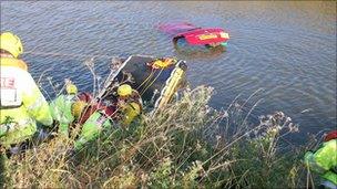 Firefighters rescue man from sinking car