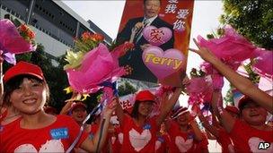 Foxconn workers carrying poster with the picture of company founder Terry Gou during a rally in Shenzhen, China, 18 August 2010