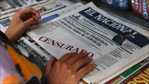 A woman buys a copy of El Nacional, whose front page carried white boxes with the words "censored" written in red (18 August 2010)