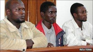 Kenyans Idris Magondu (left), Hussein Hassan and Mohammed Adan Abdow (right), stand in the dock at the Nakawa court in Kampala 30 July 2010