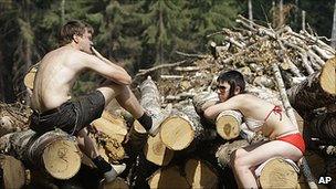 Activists sit on barricades erected to prevent loggers from cutting down a forest in the suburb of Khimki, Moscow, Russia, Monday, July 19, 2010