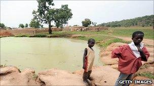 Two young boys stand next to a water hole in Dareta village, Zamfara state (June 2010)