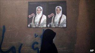 A woman walks past a campaign poster of Fauzia Galani in Herat, Afghanistan (26 August 2010)
