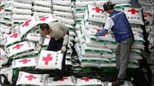 South Korean workers load fertilizer onto a ship in June 2006