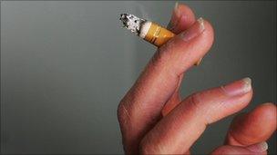 woman's hand holding a cigarette