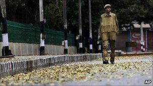 An Indian policeman patrols a deserted street during curfew in Srinagar, India on Tuesday 14 September 2010