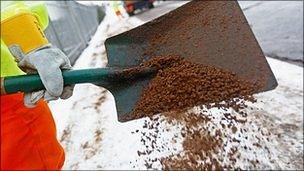 A council worker spreading salt (generic)