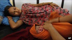 A woman with a newborn baby in Kathmandu, Nepal (10 Sept 2010)