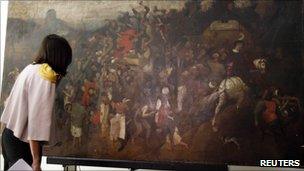 Spanish culture minister Angeles Gonzalez Sinde inspects the painting by Bruegel the Elder (23 Sept 2010)