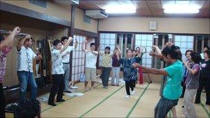 Students at Byron Fija's class practise a traditional Okinawan farewell dance
