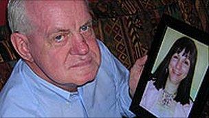 John Falding holding a photo of Anat Rosenberg