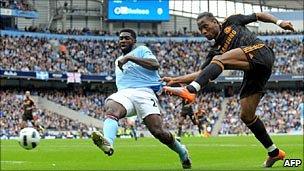 Chelsea striker Didier Drogba shoots past Manchester City defender Kolo Toure