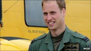 Prince William next to a rescue helicopter