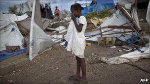 A girl stands next to tents destroyed by heavy rains in Port-au-Prince on 25 September