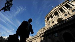 A man walking past the Bank of England