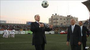 IOC president Jacques Rogge with Palestinian Prime Minister Salam Fayyad before a football match in the West Bank on Tuesday