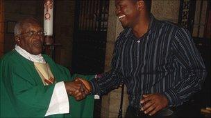 Max Katta shaking hands with Archbishop Desmond Tutu