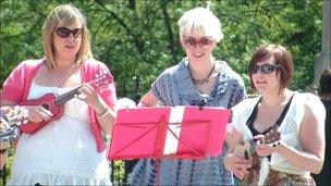 Gemma Cullingford (right) and two other members of the Norwich Ukulele Society at a gig outside the Forum in Norwich