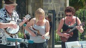 Members of the Norwich Ukulele Society outside the Forum