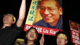 Pro-democracy protesters raise pictures of Liu Xiaobo in Hong Kong, 8 October.