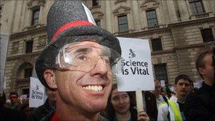 Scientists gather outside the Treasury in London to protest government cuts to science