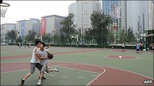 Chinese youths play basketball in a street court in Beijing