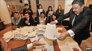 Kyrgyz election committee count ballots at a polling station in Bishkek