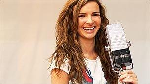 Nadine Coyle and a unusually large microphone