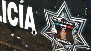 Bullet-riddled side of a police car in Sinaloa