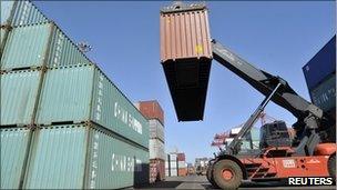 A container is unloaded from a truck at Rizhao Port in Rizhao, Shandong province