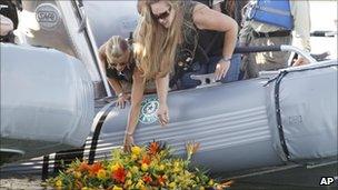 Tiffany Hartley (c) lays a wreath near the site where her husband was shot last month on Falcon Lake in Zapata, Texas (file image from Oct 6 2010)