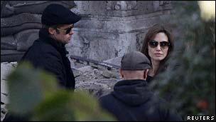 Brad Pitt (l) and Angelina Jolie with an unidentified crew member on the Budapest set of Jolie's directorial debut