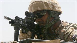 A soldier looking through his rifle scope during a patrol in Lashkar Gah, Afghanistan (file pic: 2009)