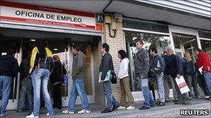 People queue outside a Spanish job centre