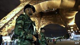 French soldiers patrol underneath the Eiffel Tower in Paris on 3 October 2010