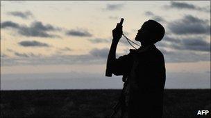 Somali gunman looks for a mobile phone signal (file photo)