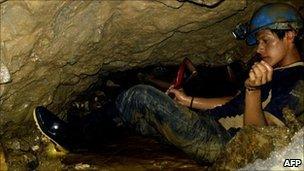 A miner tries to dig way through to reach two men trapped underground in Ecuador